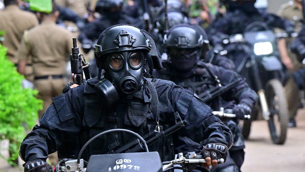 Military personnel wearing anti-riot gear patrol on bikes outside the Mahara Prison complex on the outskirts of Colombo on August 2, 2026. (AFP)