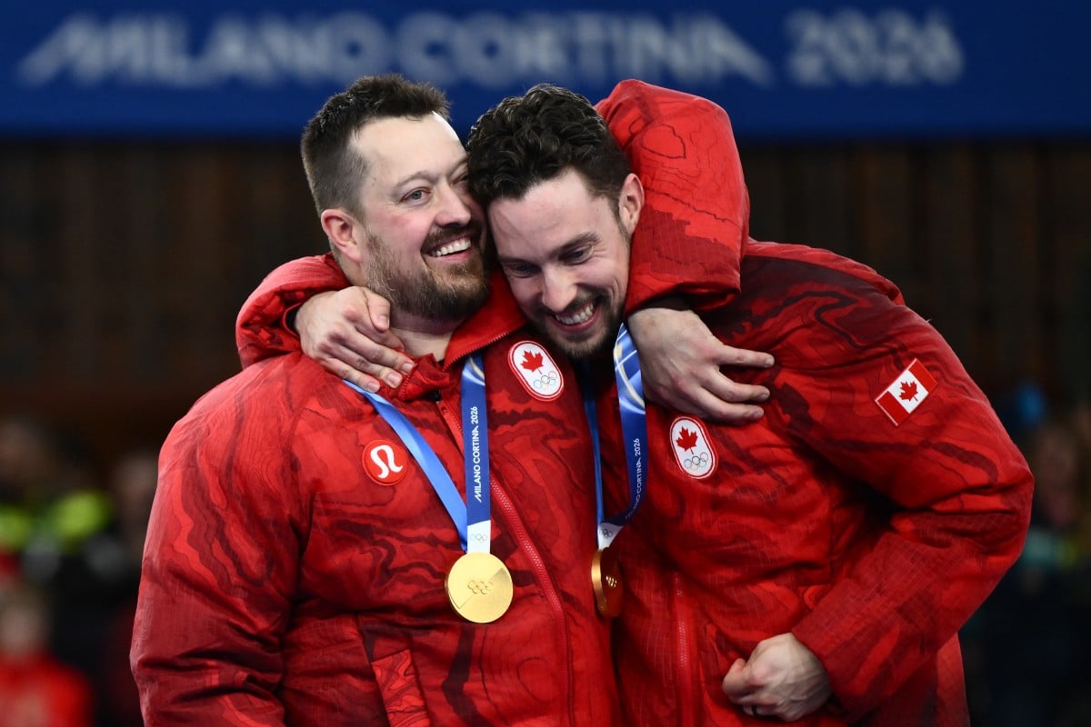 Olympic Champions from L, Canada's Ben Hebert and Canada's Brett Gallant pose with their gold medals at the ceremony during the Milano Cortina 2026 Winter Olympic Games at the Cortina Curling Olympic Stadium in Cortina d’Ampezzo on February 21, 2026. (AFP