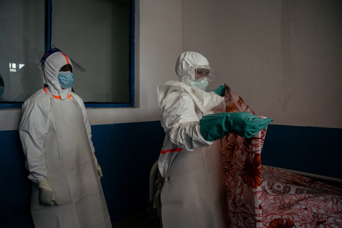 Medical personnel at CBCA Virunga Hospital wear gowns, masks, and protective gear as they prepare an isolation room for a female patient placed under 21-day observation in the suspected cases area in Goma, on May 21, 2026.