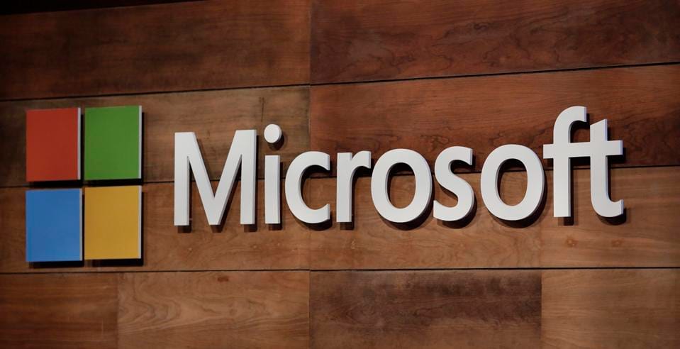 Microsoft logo displayed at the company’s annual shareholder meeting, with the stage and branding visible in the background.
