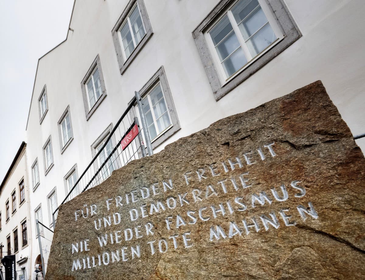 Picture taken on February 17, 2026 shows a memorial stone reading "For Peace, Freedom and Democracy - Never Again Fascism - Millions of Dead Warn" in front of the birth house of former German dictator Adolf Hitler that is turned into a police station, in
