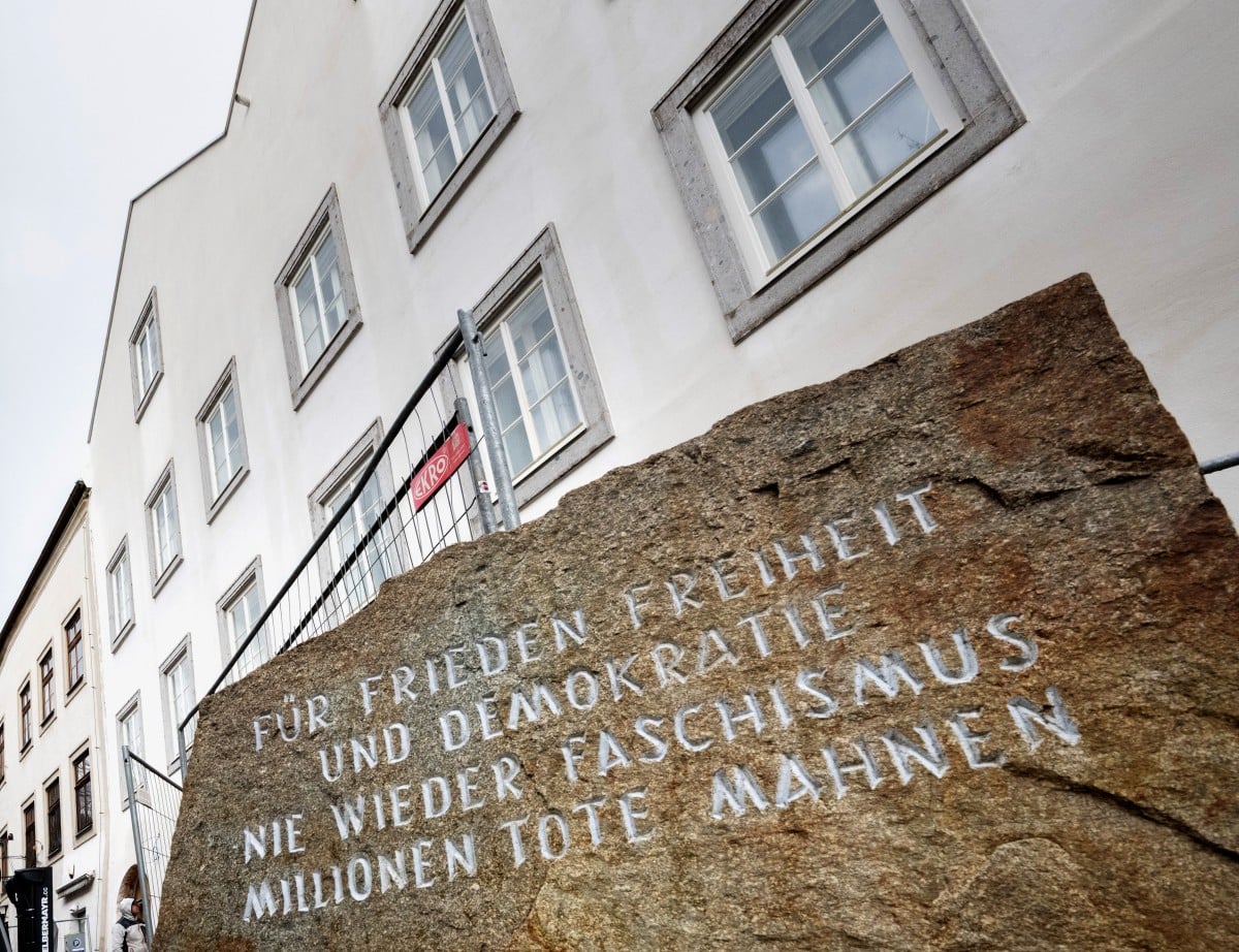 Picture taken on February 17, 2026 shows a memorial stone reading "For Peace, Freedom and Democracy - Never Again Fascism - Millions of Dead Warn" in front of the birth house of former German dictator Adolf Hitler that is turned into a police station, in
