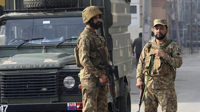 Security personnel stand guard in Peshawar on November 24, 2025. (AFP)