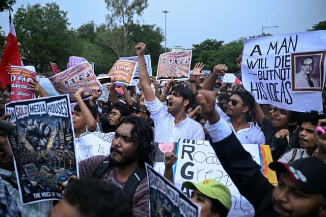 India's Cockroach Janta Party (CJP) activists hold placards and shout slogans during a protest against alleged irregularities in country's major examinations at Freedom Park in Bengaluru on June 14, 2026. (Photo by Idrees MOHAMMED / AFP)