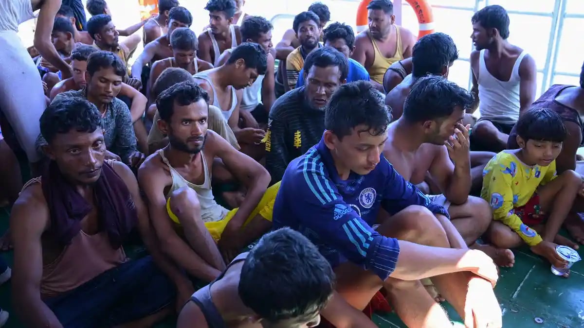 Rohingya refugees sit together on board a National Search and Rescue Agency (BASARNAS) vessel after they were rescued from their capsized boat in waters some 29 kilometers off west Aceh on March 21, 2024. (AFP)