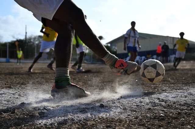 Football players take part in a training session of the Bicentini Foundation football school in the Fuik neighborhood, east of Willemstad, in the Dutch Caribbean, on April 11, 2026.
